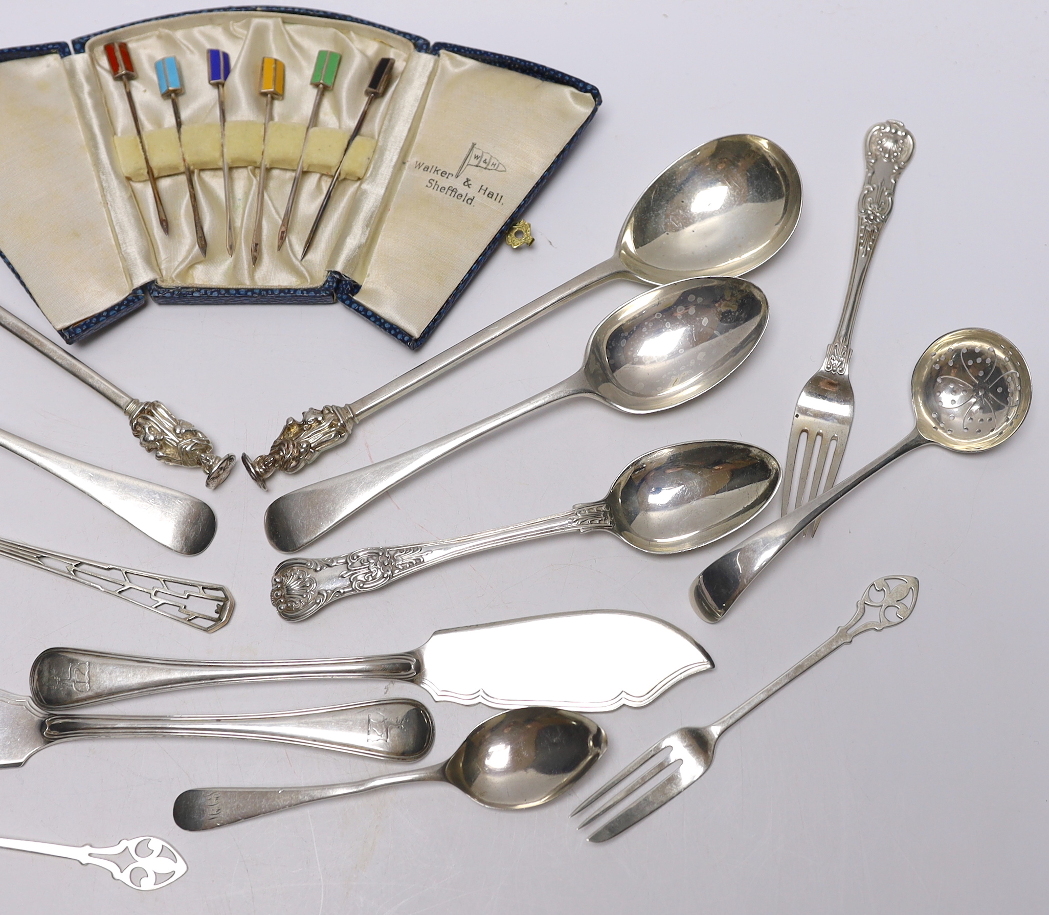 A pair of Edwardian silver apostles spoons, Josiah Williams & Co, London, 1902, 19.5cm and a small quantity of assorted silver flatware including pair of Victorian butter knives and a case of six silver and enamel cockta